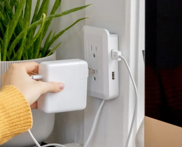 woman putting MagicOutlet on wall