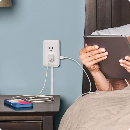 woman using MagicOutlet to charge multiple devices