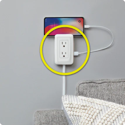 MagicOutlet on wall with phone on it